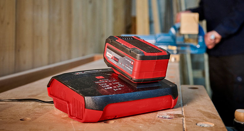 Einhell battery being charged in a boost charger